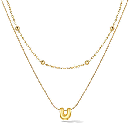 Gold layered initial U necklace with letter 'U' pendant, showing measurements and material details.