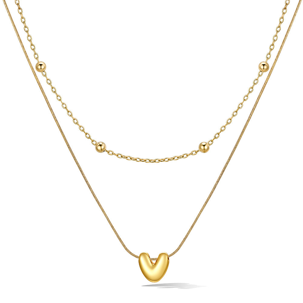 Gold layered initial V necklace with letter 'V' pendant, showing measurements and material details.
