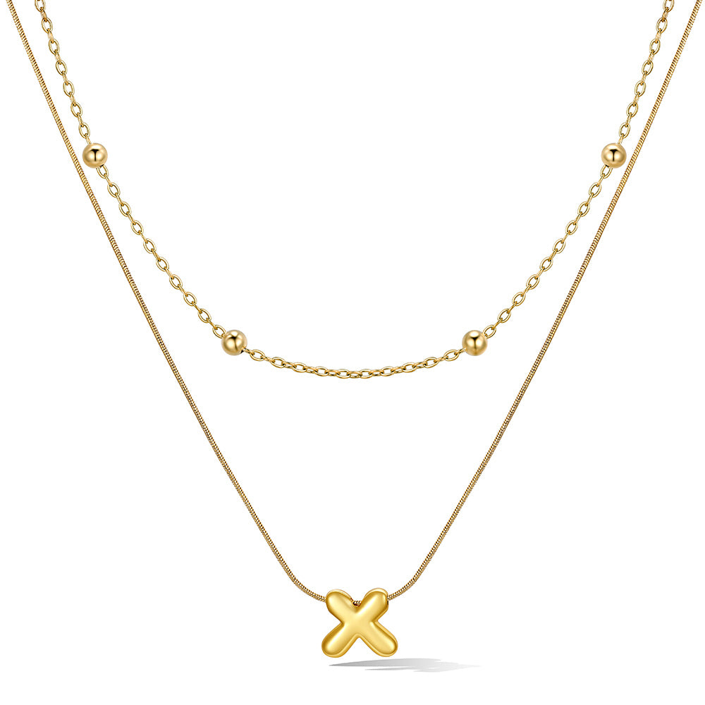 Gold layered initial X necklace with letter 'X' pendant, showing measurements and material details.