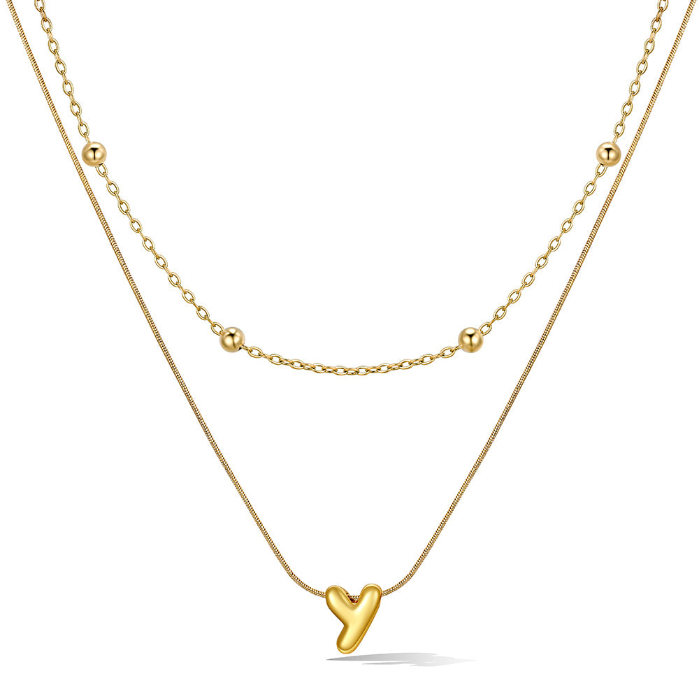 Gold layered initial Y necklace with letter 'Y' pendant, showing measurements and material details.