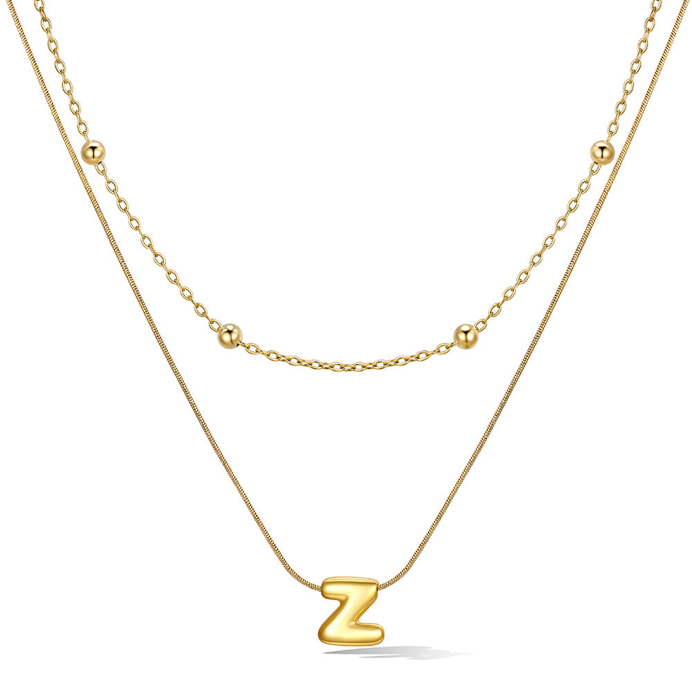 Gold layered initial Z necklace with letter 'Z' pendant, showing measurements and material details.