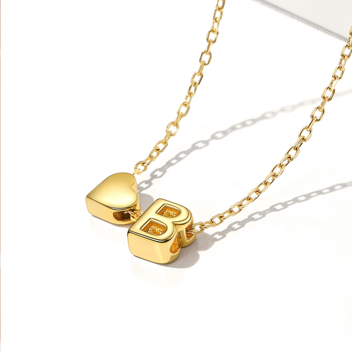 Gold necklace with a heart-shaped pendant and letter 'B'
