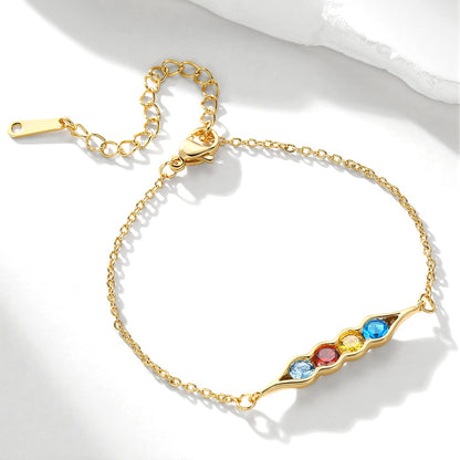 Gold pea in pot bracelet with colorful gemstones on a white background
