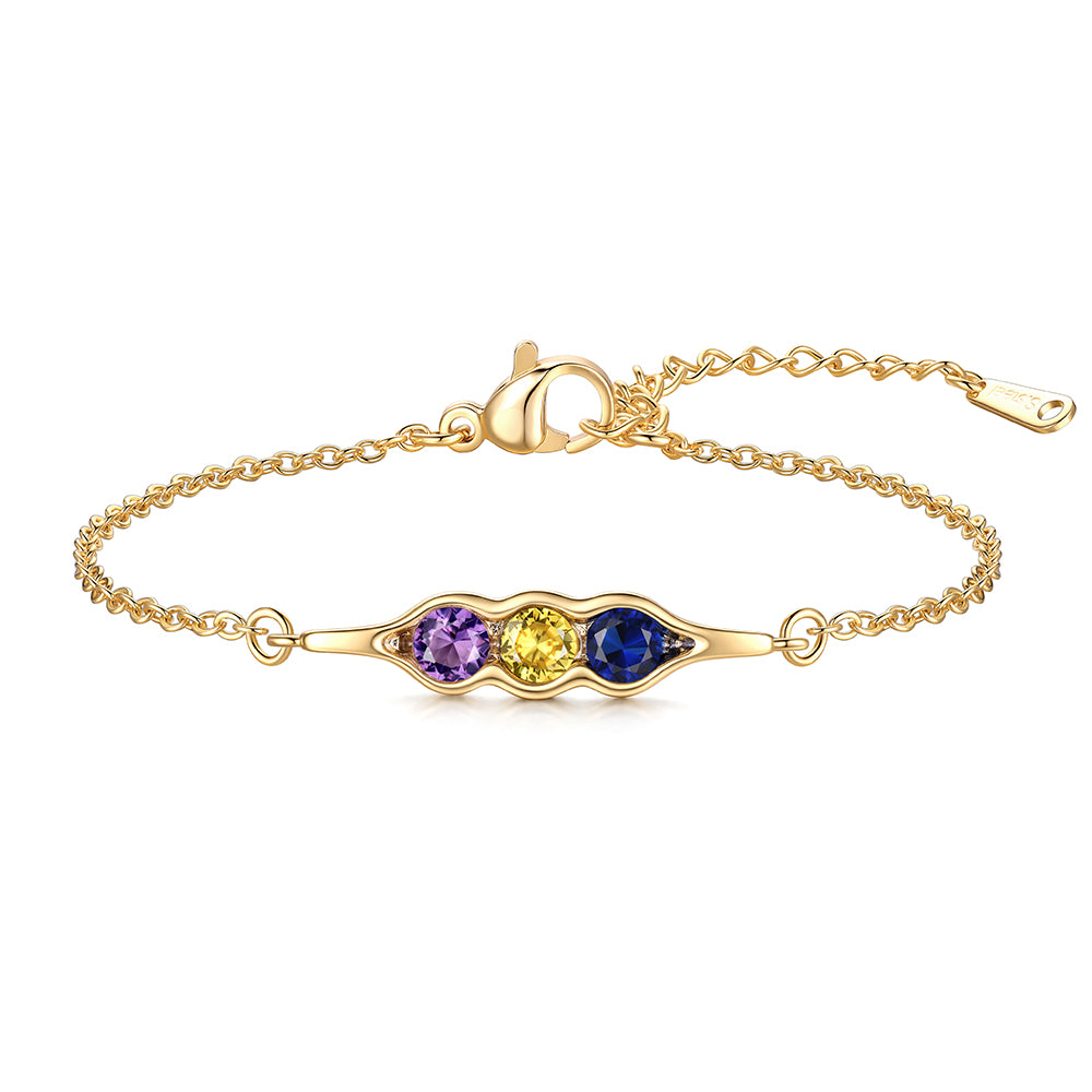 Gold pea in pot bracelet with three colored stones on a white background