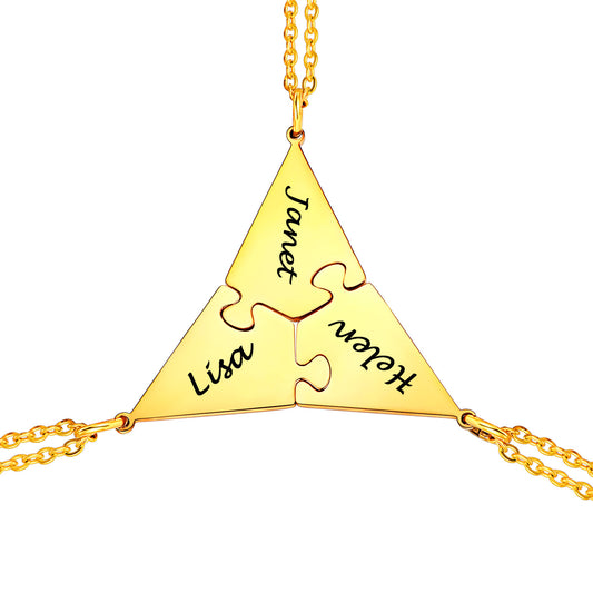 Gold puzzle matching necklace with interlocking puzzle pieces and engraved names on a white background