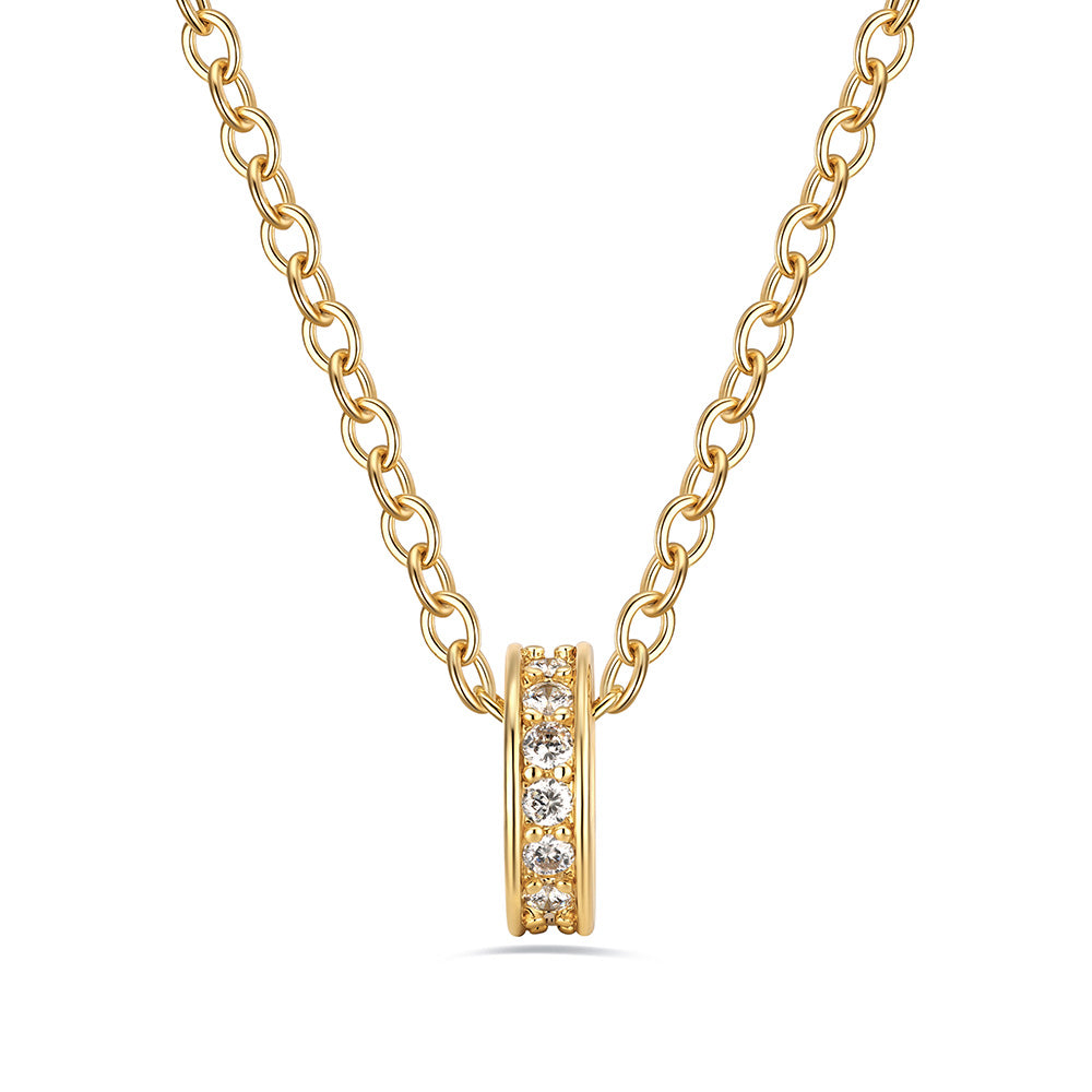 Gold stacking birthstone necklace with a small round pendant on a white background
