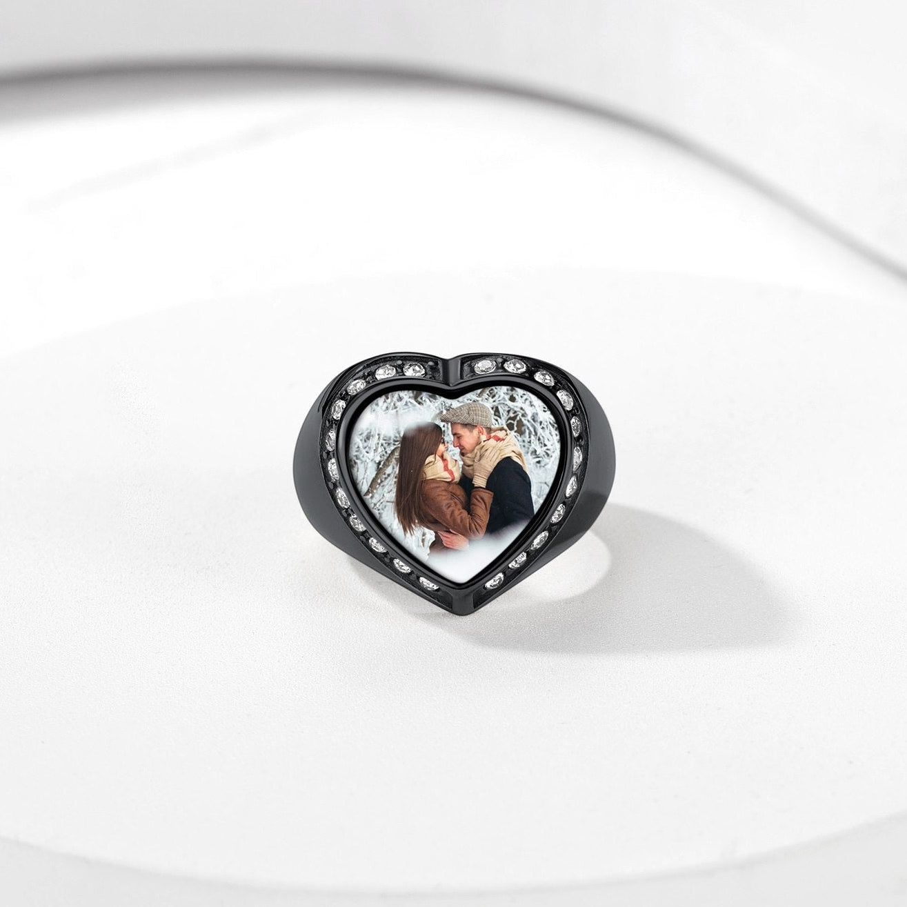 Heart-shaped photo signet ring with a couple's photo on a white background
