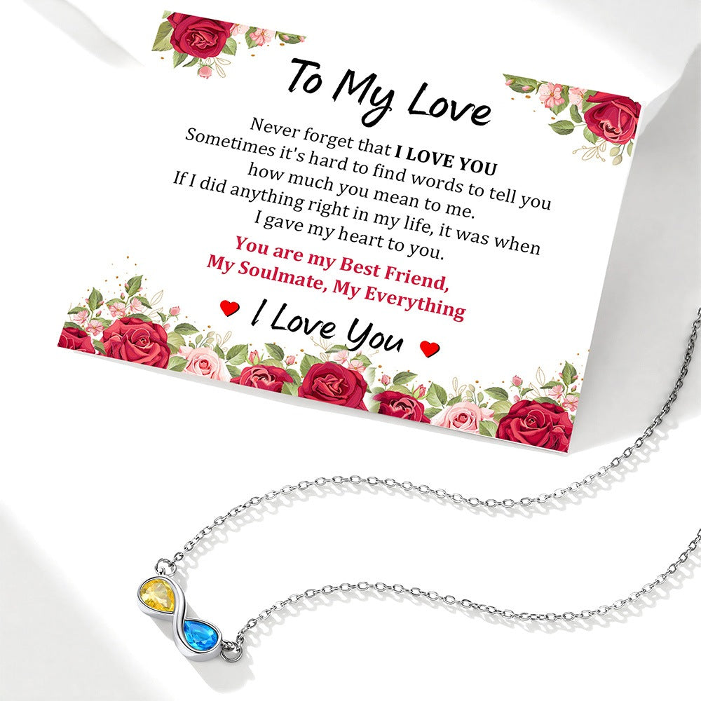 Infinity Necklace on a card with floral designs and text.