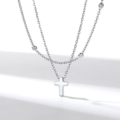 Layered Silver cross necklace on a white background