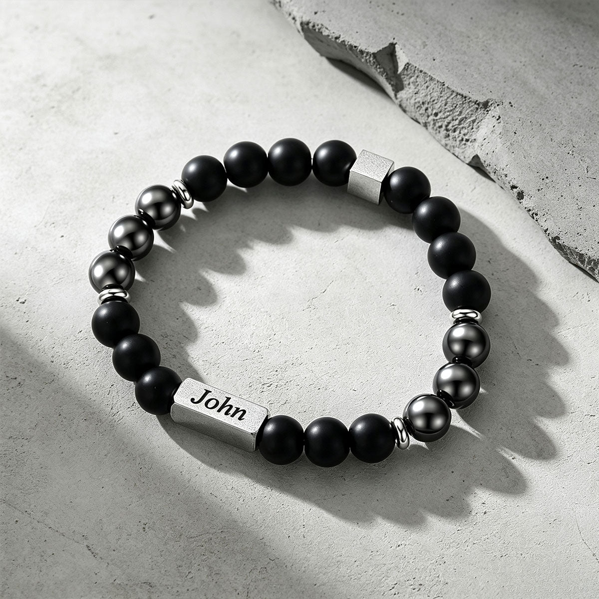 Magnetic Hematite Beaded Bracelet on a cement background