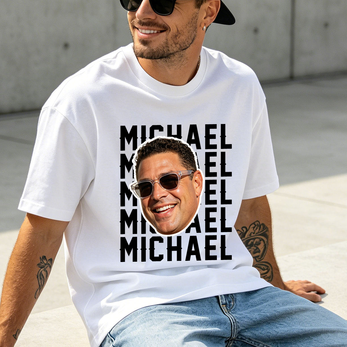 Man wearing a funny face white t-shirt with 'MICHAEL' printed multiple times and a photo of a smiling man with sunglasses.