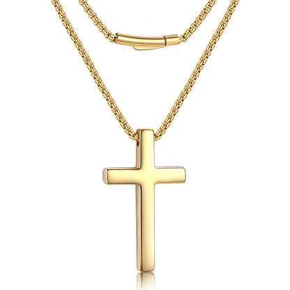 A gold cross pendant necklace with a layered chain design, featuring a polished cross pendant and a matching chain with a small cylindrical clasp, shown on a white background.