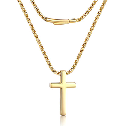 A gold double-layer necklace featuring a classic box chain and a polished cross pendant, displayed against a clean white background.