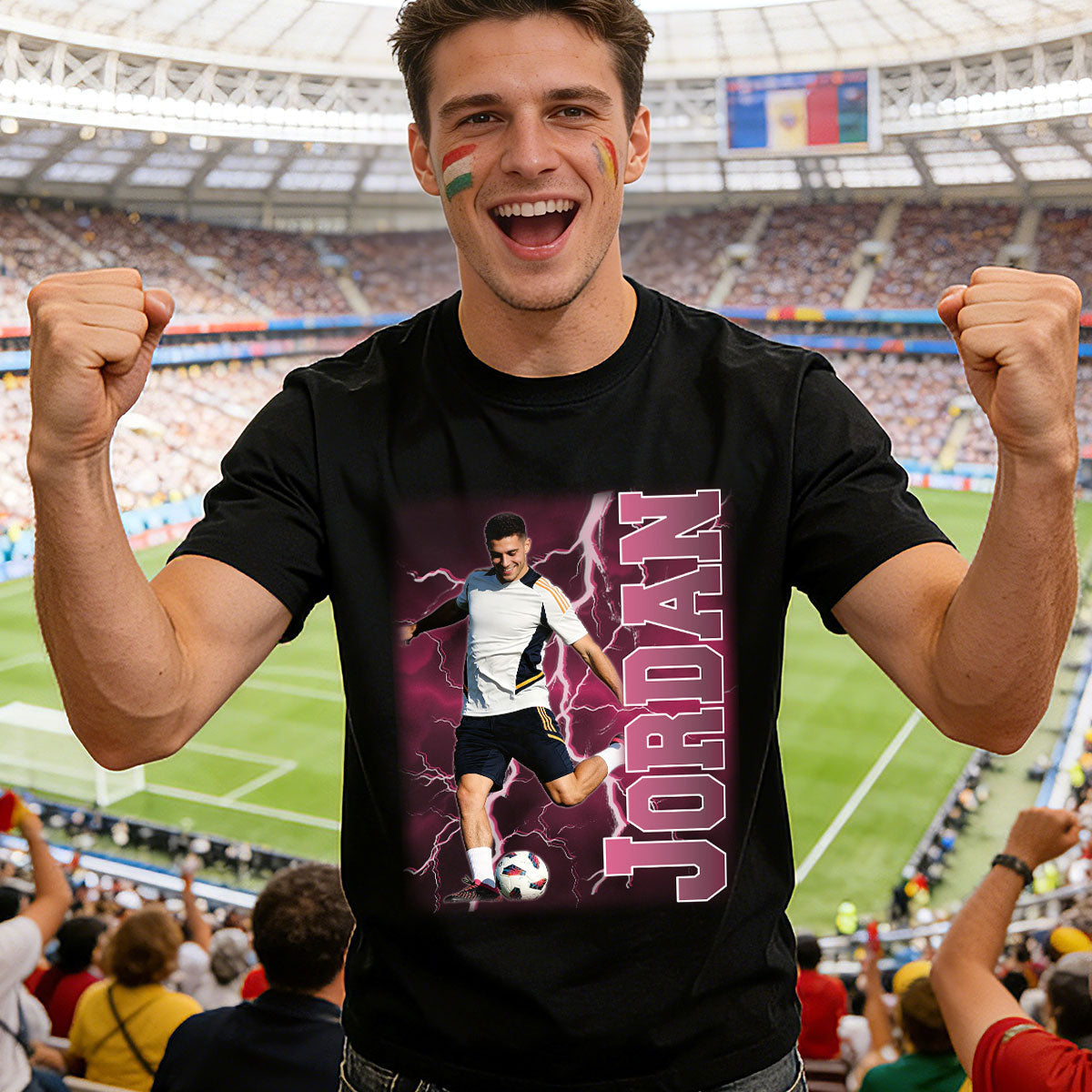 Person wearing a black t-shirt with a graphic design of a soccer player and the name 'Jordan' in a stadium.