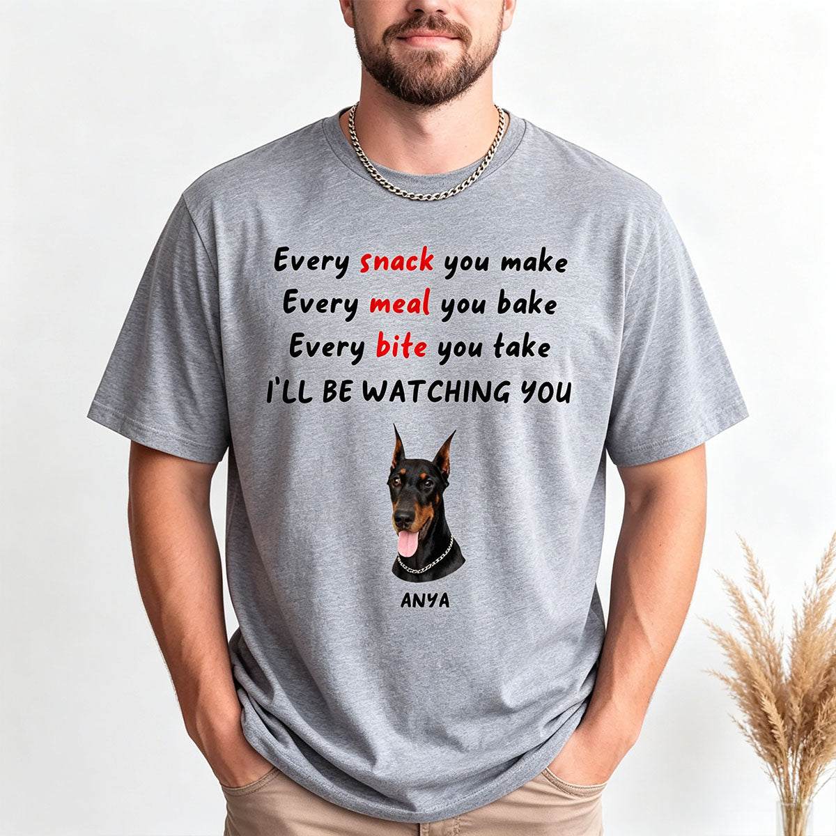 Person wearing a gray t-shirt with a dog graphic and text on a white background