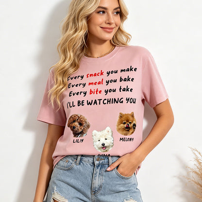 Person wearing a pink t-shirt with dog illustrations and text on a white background