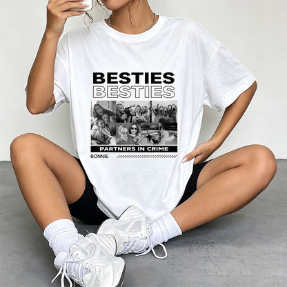 Person wearing a white besties t-shirt with 'Besties' design sitting on the floor.