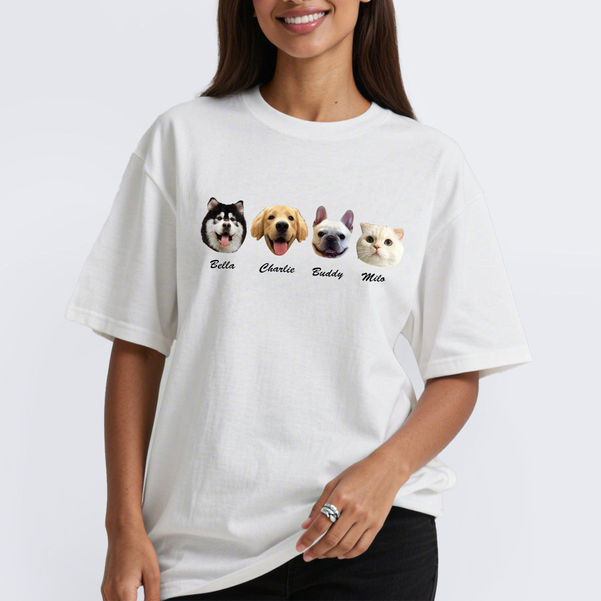 Person wearing a white t-shirt with dog illustrations and names on a white background