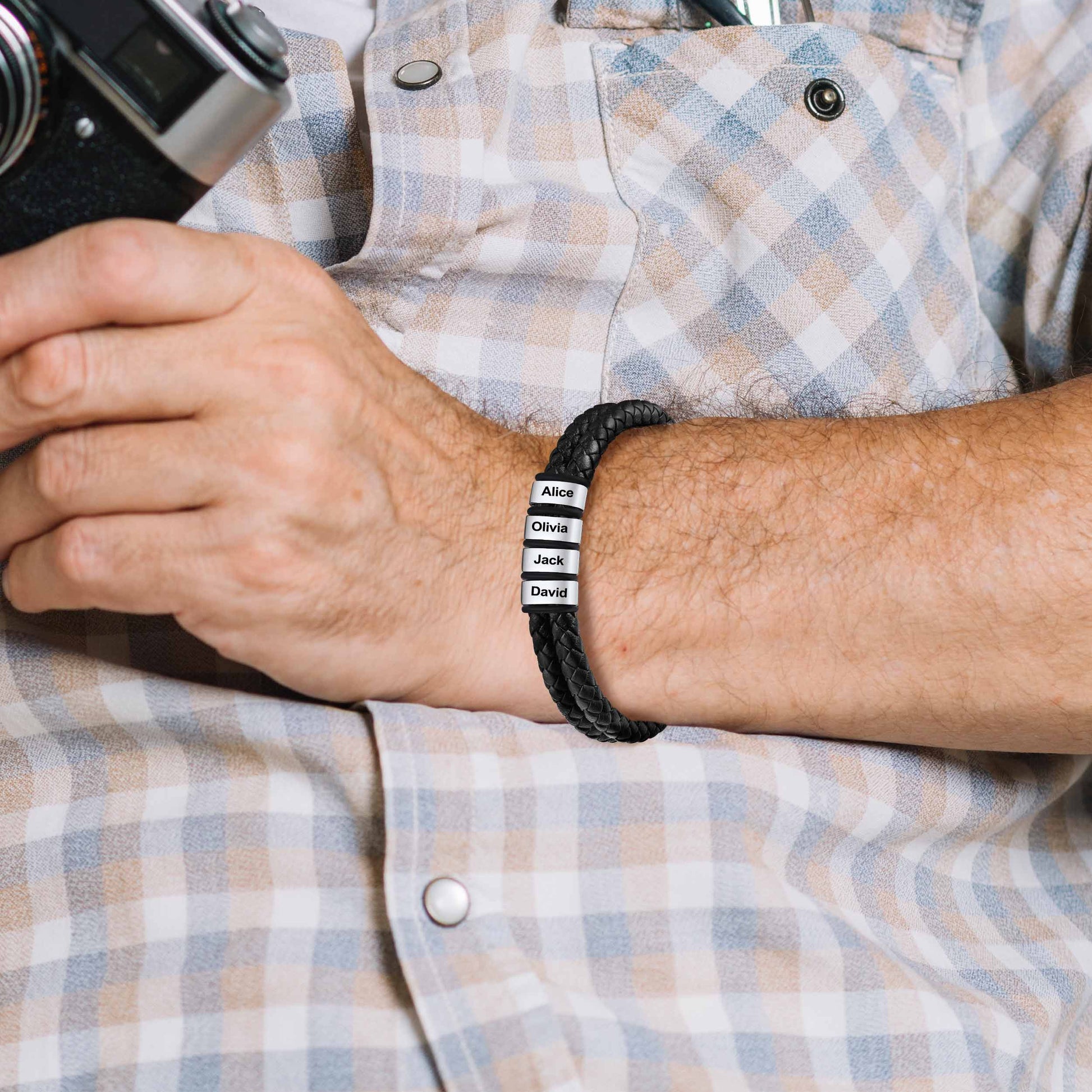 A Man Wearing custom name engraved leather bracelet in a plaid shirt