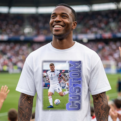 Man wearing a white t-shirt with a soccer player graphic and 'CUSTOM' text in a stadium setting