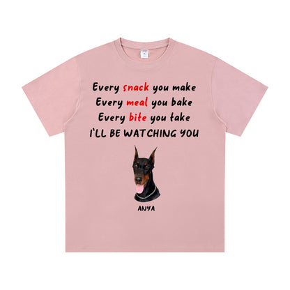 Pink t-shirt with a dog illustration and humorous text on a white background