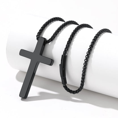 Black cross pendant necklace and bracelet on a white background