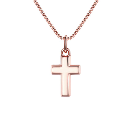 Rose gold cross pendant on a chain against a white background