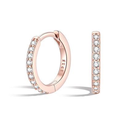 Rose gold cz hoop earrings with diamonds on a white background