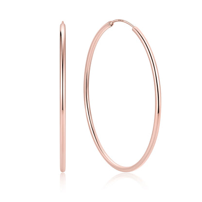 Rose gold hoop earrings on a white background