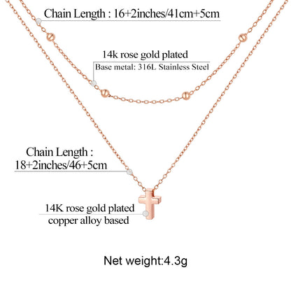 Rose gold laytered cross necklace with cross pendant and chain length details on a white background