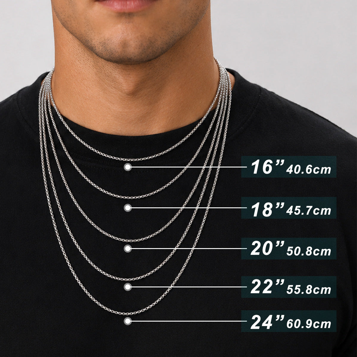 A close-up of a man wearing layered silver chain necklaces over a black shirt, with overlaid size labels showing recommended lengths for women's and men's necklaces.