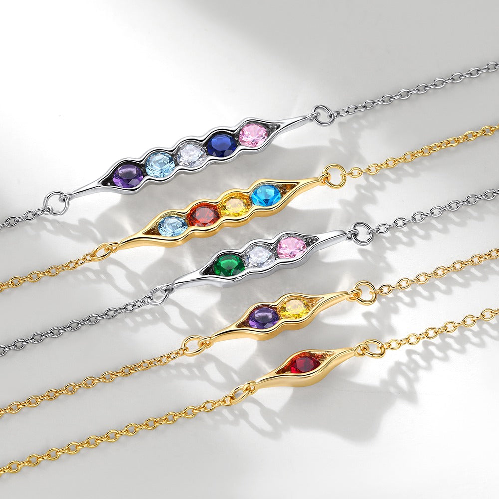 Set of colorful gemstone peat in pot bracelets on a light background
