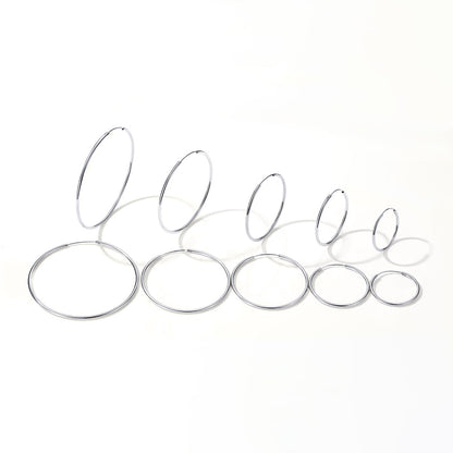 Set of hoop earrings in different size on a white background