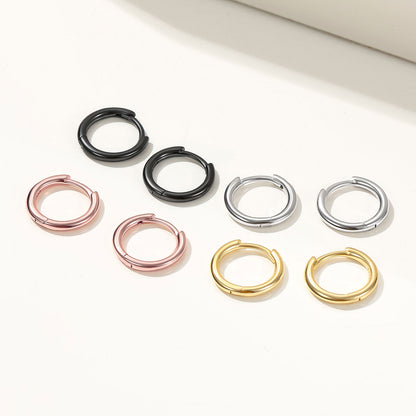 Set of hoop earrings in various colors on a light background