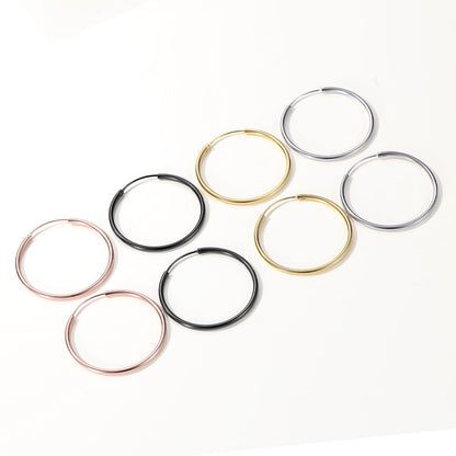 Set of hoop earrings in various colors on a white background