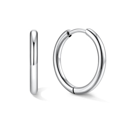 Silver 14mm huggie earrings on a white background