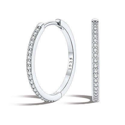 Silver 20mm huggie earrings with embedded stones on a white background