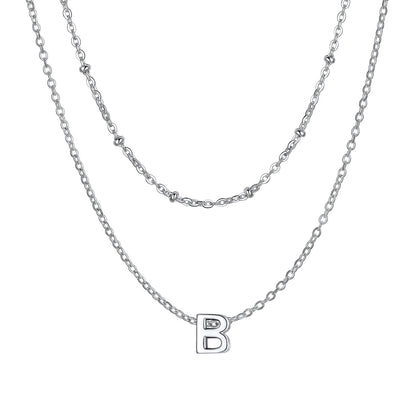 Silver B Layered initial W necklace on a white background