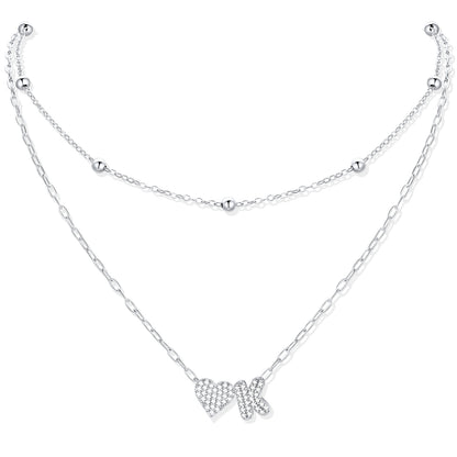 Silver CZ initial k necklace with a heart-shaped pendant on a white background