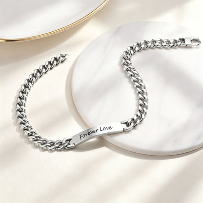 Silver Cuban chain necklace with 'Forever Love' engraving on a white surface