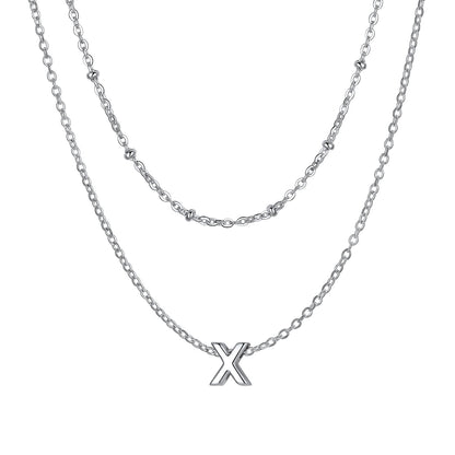 Silver Layered initial X necklace on a white background