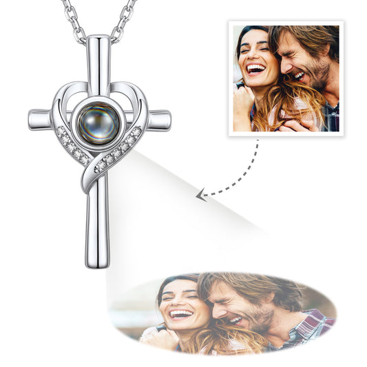 Silver cross-shaped Projection surrounded by photos of a couple