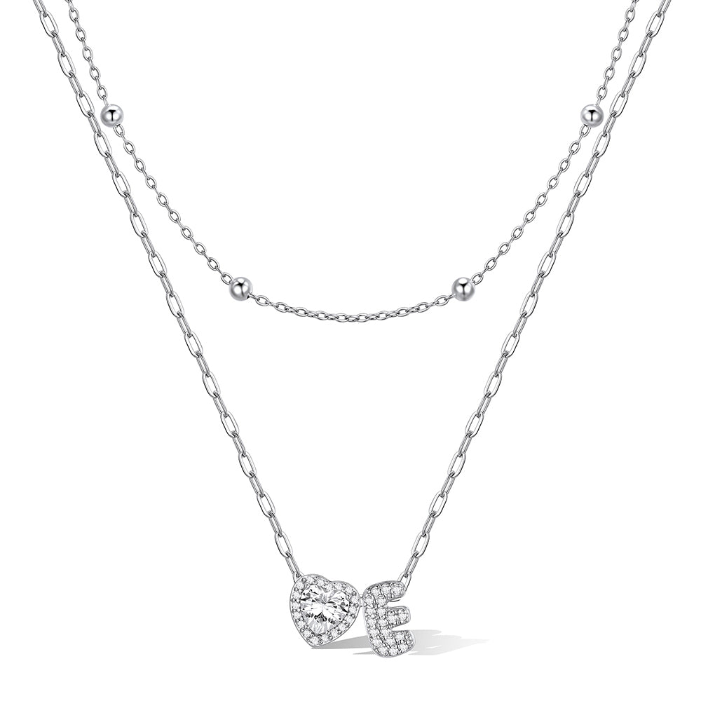 Silver cz bubble initial E necklace with a heart-shaped pendant on a white background