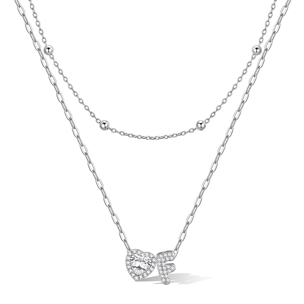 Silver cz bubble initial F necklace with a heart-shaped pendant on a white background