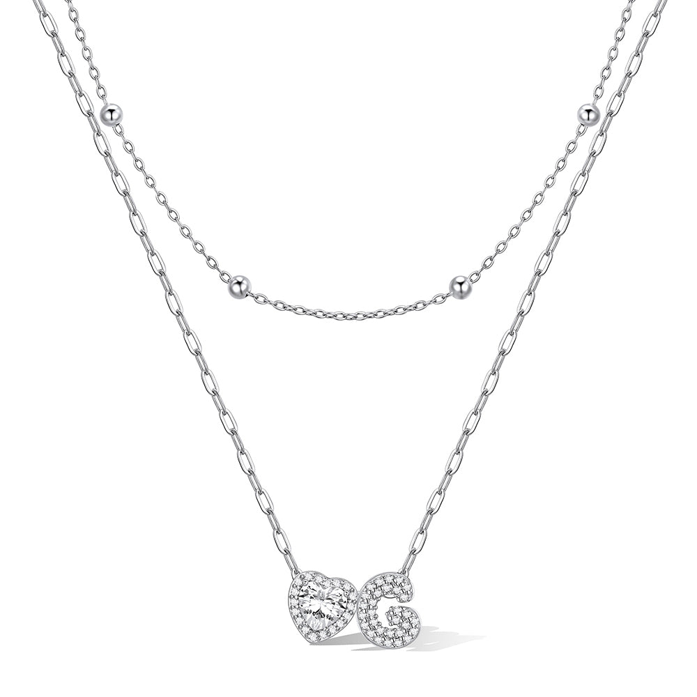 Silver cz bubble initial G necklace with a heart-shaped pendant on a white background