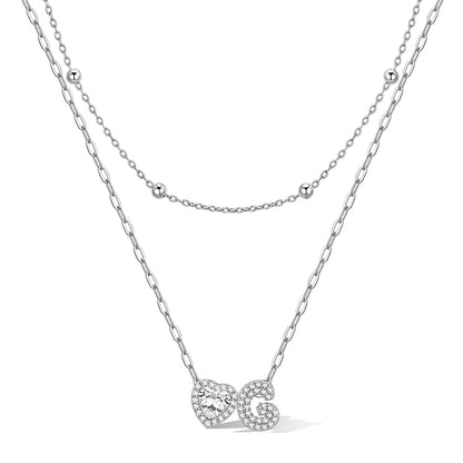 Silver cz bubble initial G necklace with a heart-shaped pendant on a white background