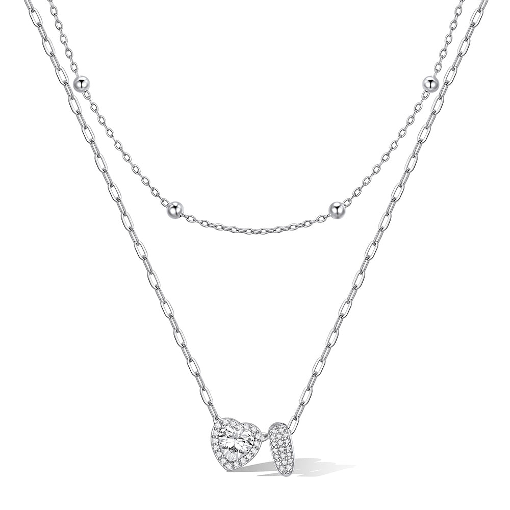 Silver cz bubble initial I necklace with a heart-shaped pendant on a white background