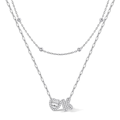 Silver cz bubble initial K necklace with a heart-shaped pendant on a white background