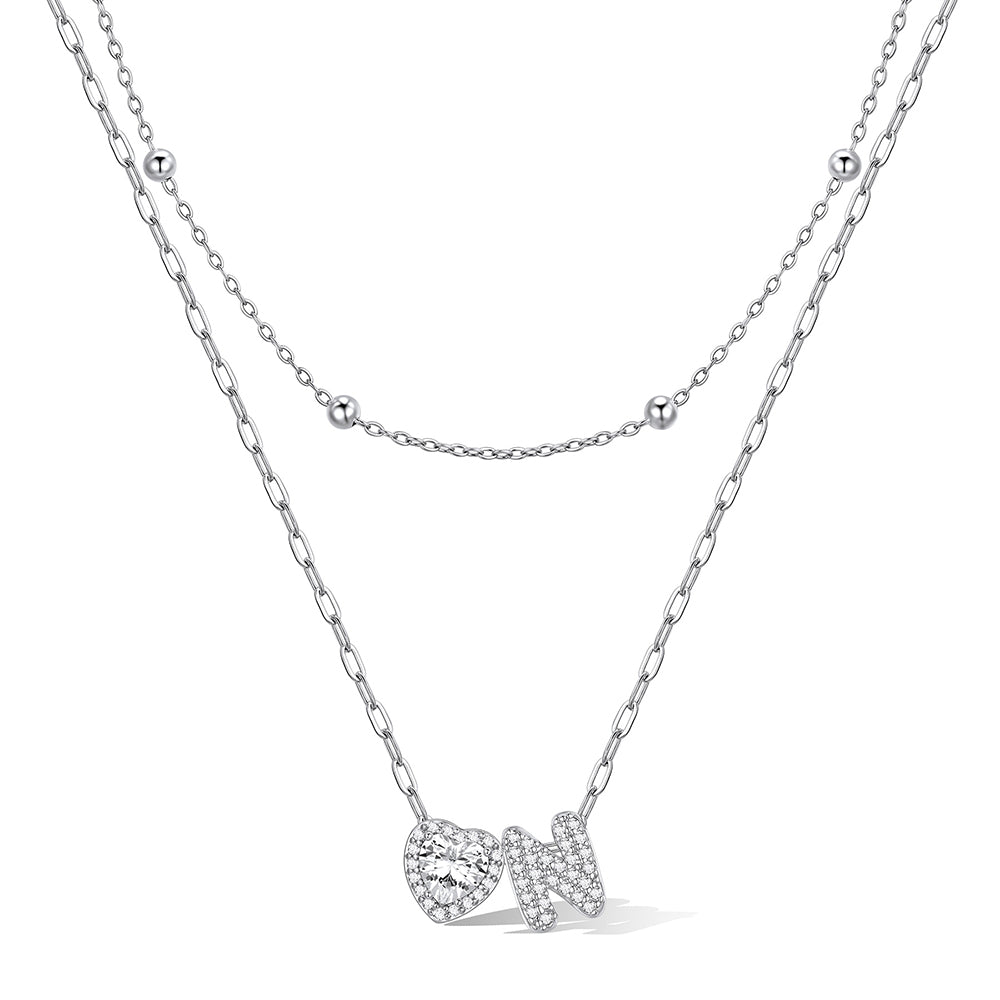 Silver cz bubble initial N necklace with a heart-shaped pendant on a white background
