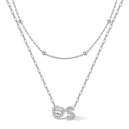 Silver cz bubble initial S necklace with a heart-shaped pendant on a white background